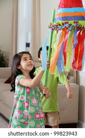 Kids Hitting A Pinata At Birthday Party