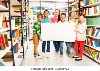 Kids Holding White Paper Sheet In Library