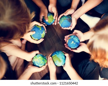 Kids holding the world in their hands