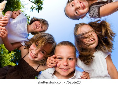 Kids In A Huddle Having Fun And Looking Down