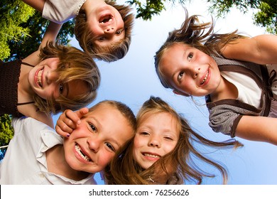 Kids In A Huddle Having Fun And Looking Down