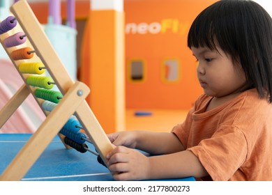 Kids Intend Learn From Play With Colorful Wooden Toy On Table Desk At Home. Preschool Young Girl Concentrating With Educational Block In Recess Term Back To School Children At Home Or Daycare Child.