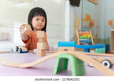 Kids Intend Learn From Play With Colorful Wooden Toy On Table Desk At Home. Preschool Young Girl Concentrating With Educational Block In Recess Term Back To School Children At Home Or Daycare Child.