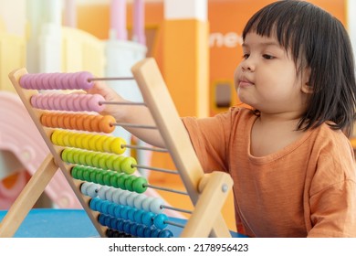 Kids Intend Learn From Play With Colorful Wooden Toy On Table Desk At Home. Preschool Young Girl Concentrating With Educational Block In Recess Term Back To School Children At Home Or Daycare Child.