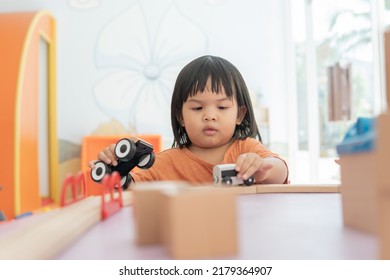 Kids Intend Learn From Play With Colorful Wooden Toy On Table Desk At Home. Preschool Young Girl Concentrating With Educational Block In Recess Term Back To School Children At Home Or Daycare Child.