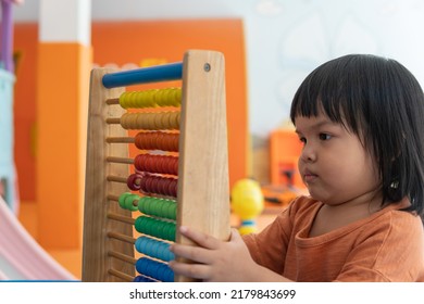 Kids Intend Learn From Play With Colorful Wooden Toy On Table Desk At Home. Preschool Young Girl Concentrating With Educational Block In Recess Term Back To School Children At Home Or Daycare Child.