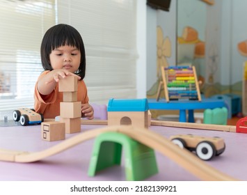 Kids Intend Learn From Play With Colorful Wooden Toy On Table Desk At Home. Preschool Young Girl Concentrating With Educational Block In Recess Term Back To School Children At Home Or Daycare Child.