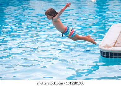 Kids Jumping In Pool. Happy Child Swimming In The Pool