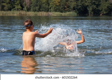 Kids Jumping, Swimming And Playing With Water In A Polish Lake, Summer Holiday In Greater Poland. Leisure - Boys Point Of View. Beautiful Childhood.