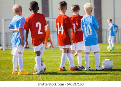 Kids Junior Football Training Session. Soccer Training For Kids. Children Practice Soccer On The Pitch