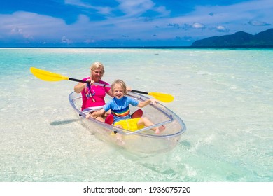 Kids kayaking in ocean. Children in kayak in tropical sea. Active vacation with young kid. Parents, little boy and girl in canoe on beautiful beach. Holiday activity with child. Family water fun.