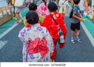 Kids With Kimono At Japanese Summer Festival In A Small Town