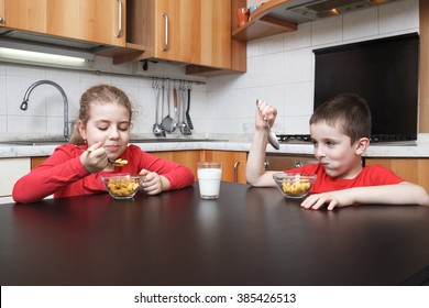 kids in the kitchen eating cereals