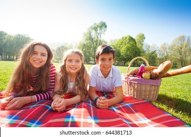 Kids Laying On The Picnic Blanket In Summertime