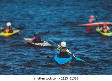 Kids learn kayaking, canoeing whitewater training in the lake river, children practicing paddling, yound kayakers in summer camp
