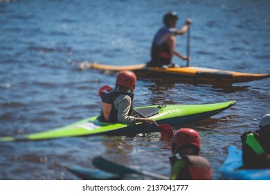 Kids learn kayaking, canoeing whitewater training in the lake river, children practicing paddling, yound kayakers in a summer camp
				