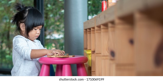 Kids Learnfrom Play With Colourful Wooden Toy On Table Top At Home. Preschool Young Girl Concentrate With Educational Equipment In Recess Term Back To School Children At Home Or Daycare Kindergarten.