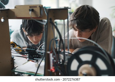 Kids Learning 3D Printing In The Lab, The Are Staring At The 3D Printer Printing Their Prototype