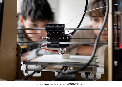 Kids Learning 3D Printing In The Lab, The Are Staring At The 3D Printer Printing Their Prototype