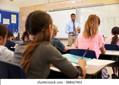 Kids Listening To Teacher At An Elementary School Class