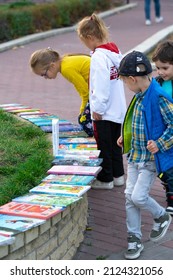 Kids Looking For Children Books. Children Choose Books. Kids Watching Children's Literature At A Book Fair. Sale Of Children's Books In The Park.
October 14, 2019, Kyiv, Ukraine