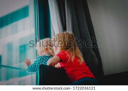kids looking at the window while staying home, girls being homesick