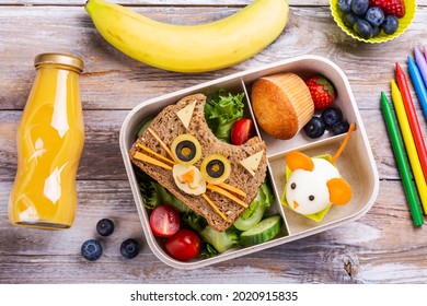 Kids Lunch Box With Cute Cat Sandwich, Muffin And Mouse Made From Boiled Egg. Back To School Breakfast Background - Lunch Box, Bottle Of Orange Juice And Green Apple. Top View. Copy Space