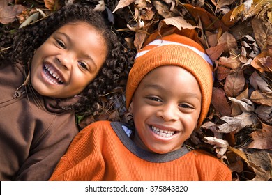 Kids lying on leaves