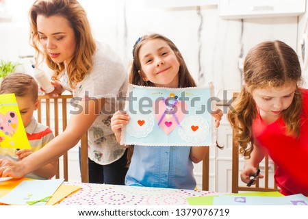 Kids make greeting cards for Mother's day holiday