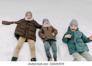 Kids Making Snow Angels On Snow, Laughing.