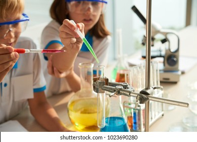 Kids Mixing Reagents In Test-tube At Chemistry Class