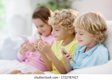 Kids With Mobile Phone. Child With Tablet Computer Watching Movie Or Playing Game. Group Of Little Children With Digital Device And Gadget. Screen Time And Education For Young Kid. Friends Play.