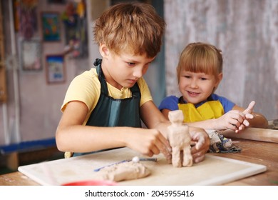 Kids  Molded From Clay At Pottery Class.
