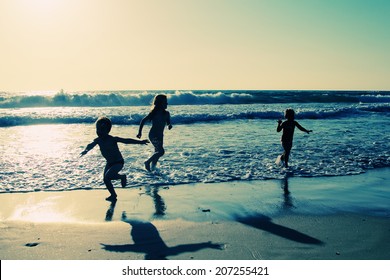Kids On The Beach At Sunset