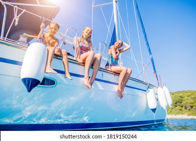 Kids On Board Of Sailing Yacht On Summer Cruise. Travel Adventure, Yachting With Child On Family Vacation.