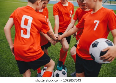 Kids on Football Soccer Team Putting Hands in. Boys Football School Team Huddling. Children Hands Together in a Huddle - Powered by Shutterstock