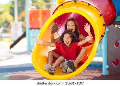 Kids on playground. Children play outdoor on school yard slide. Healthy activity. Summer vacation fun. Child playing in sunny park. Kid having fun on colorful slide. - Shutterstock ID 2168171107