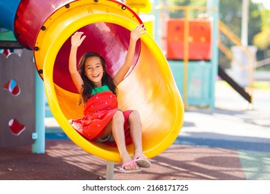 Kids on playground. Children play outdoor on school yard slide. Healthy activity. Summer vacation fun. Child playing in sunny park. Kid having fun on colorful slide. - Powered by Shutterstock