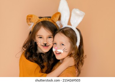 Kids with painted faces in guise of rabbit and tiger. Zodiac 2023 year according to Chinese calendar. Girl dressed up with bunny ears and makeup in anticipation new year. Symbol outgoing old year 2022 - Shutterstock ID 2154269503