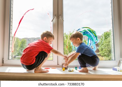 Kids Painting A Rainbow On The Window