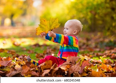 Kids Play In Autumn Park. Children Throwing Yellow And Red Leaves.Baby With Oak And Maple Leaf. Fall Foliage. Family Outdoor Fun In Autumn. Toddler Kid Or Preschooler Child In Fall.