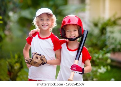 Kids play baseball. Child with bat and ball. Outdoor activity for healthy kids. Fun team ball game for boy and girl. Young athlete on baseball field. Little boy with helmet for safe exercise. - Powered by Shutterstock