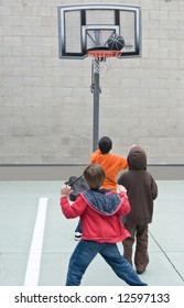 Kids Play Basketball In A School.