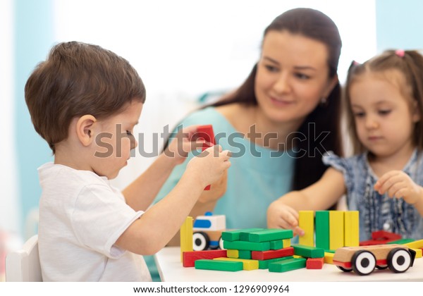 Kids play with\
block toy in day care\
center