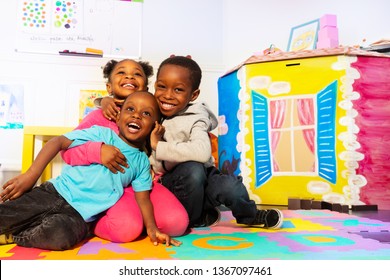 Kids play and hug in kindergarten room
