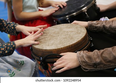 Kids Play Jembe Drum In A Montessori Music Therapy Classroom With Parents, Hands Close Up