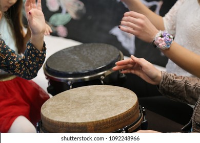 Kids Play Jembe Drum In A Montessori Music Therapy Classroom With Parents, Hands Close Up