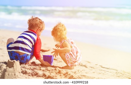 Kids Play With Sand On Summer Beach