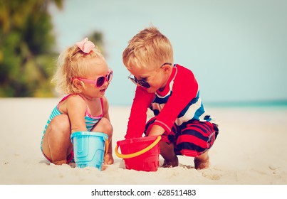 Kids Play With Sand On Summer Beach