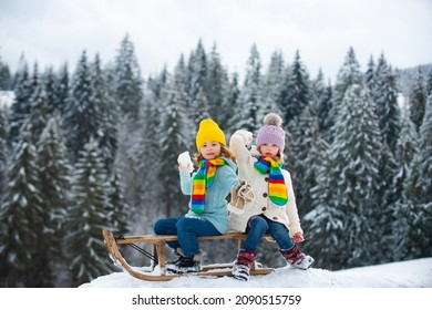 Kids Play Snowball, Snow Ball Fight For Children. Children Son And Daughter Play In Snow In Winter. Outdoor Kids Fun For Christmas Family Vacation.